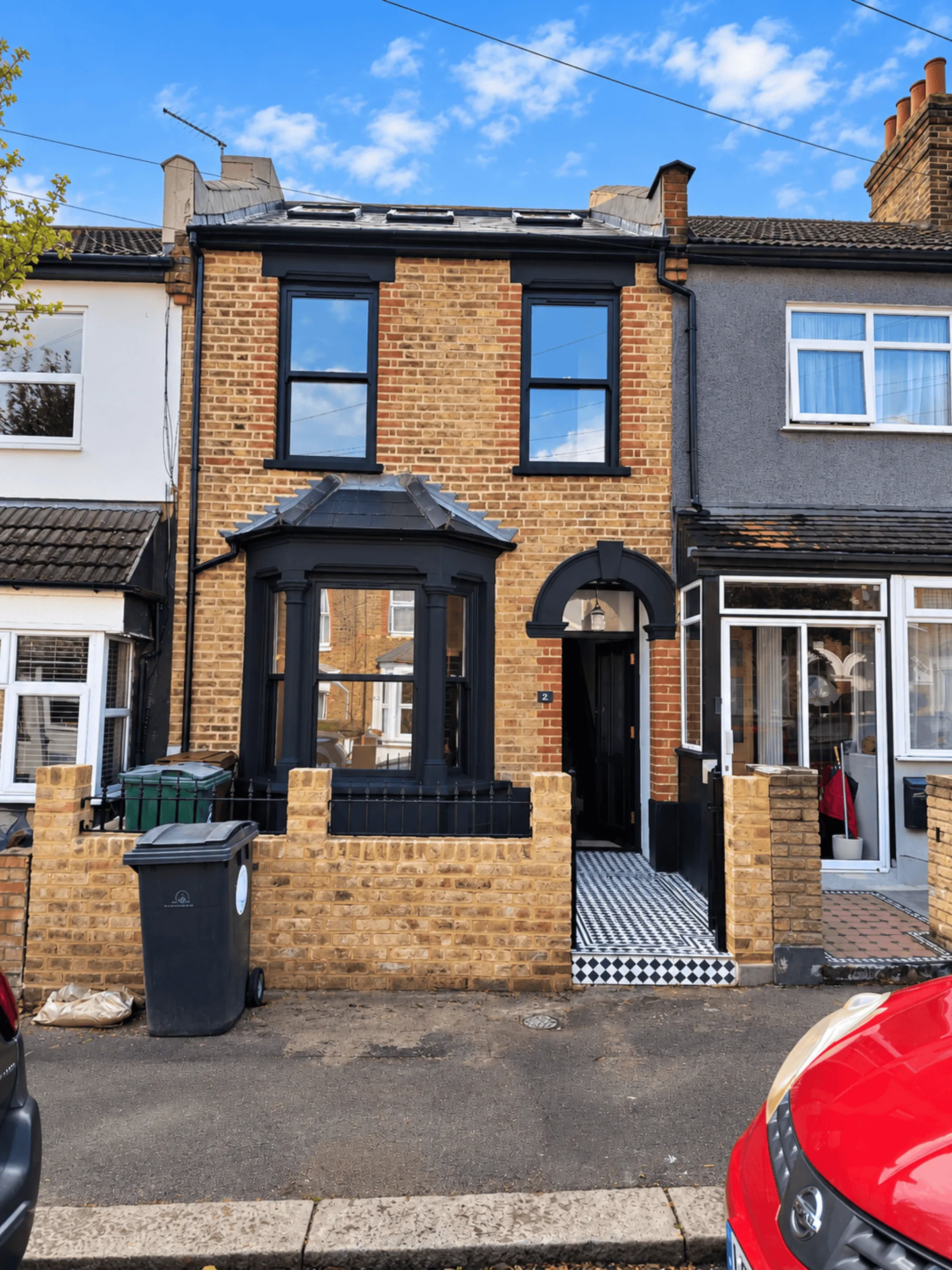 Rear extension with Crittall-style glazed doors opening onto a landscaped garden