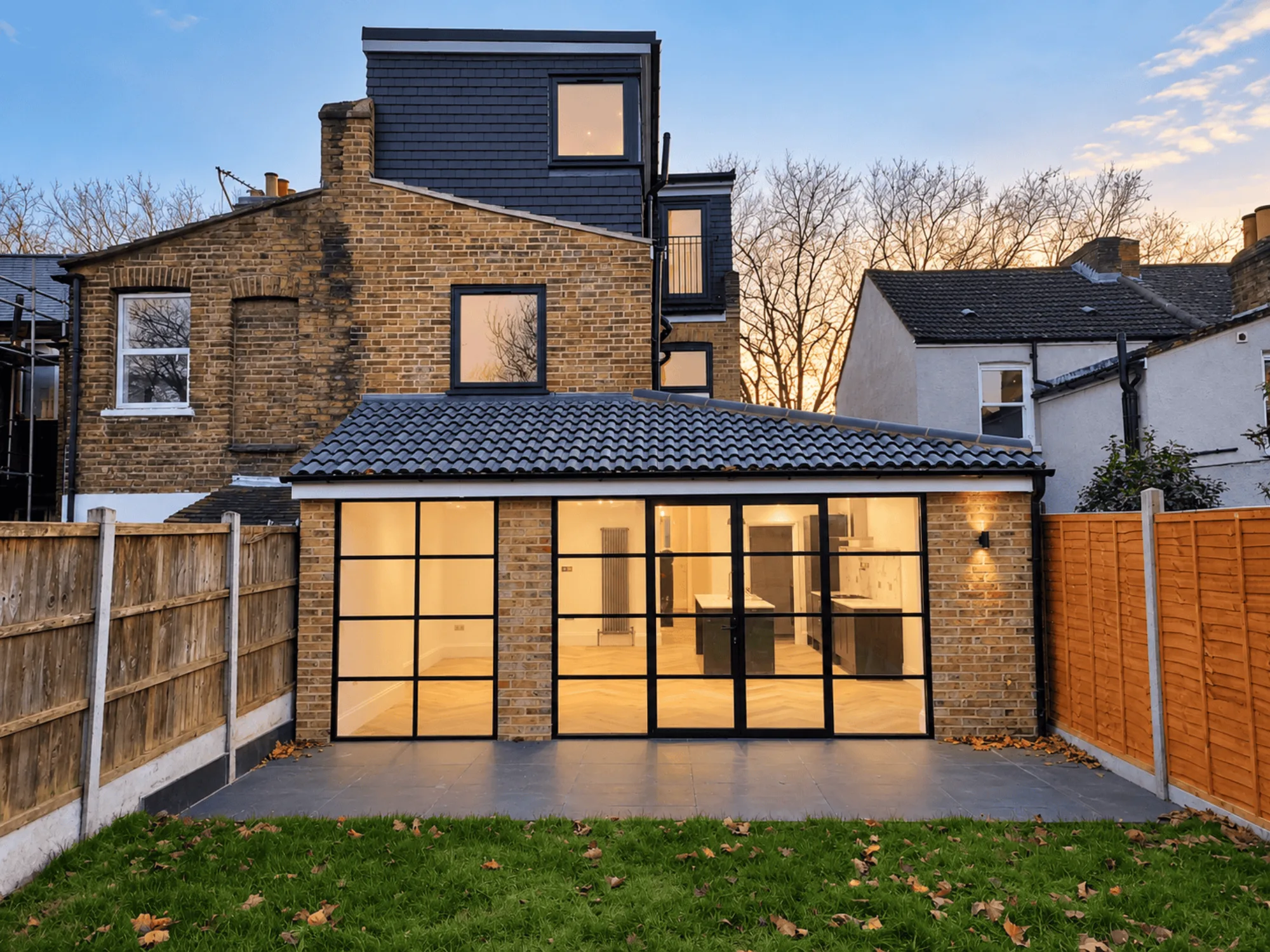 Rear extension and dormer loft conversion on a Walthamstow terrace with a steel-framed glazed wall