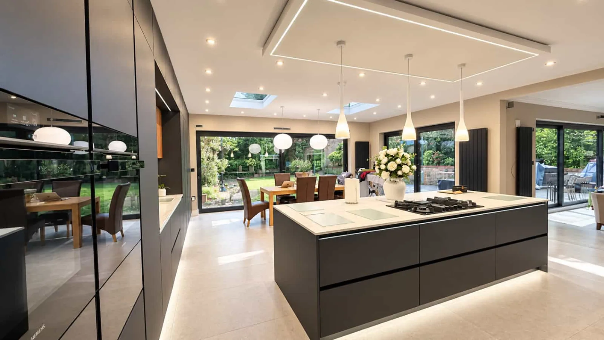 Architect-designed open-plan kitchen and dining extension with skylights and sliding glass doors